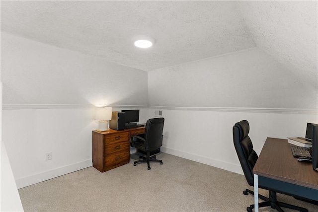 carpeted office with vaulted ceiling, a textured ceiling, and baseboards