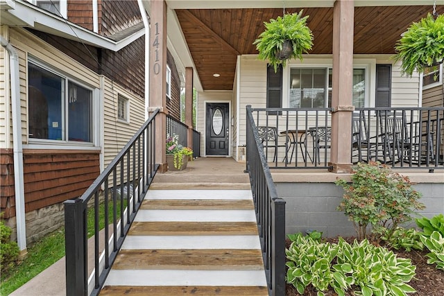 view of exterior entry with a porch