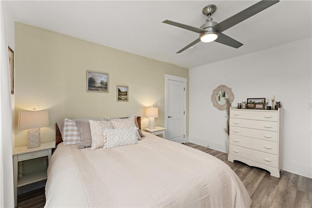 bedroom featuring wood finished floors, baseboards, and ceiling fan