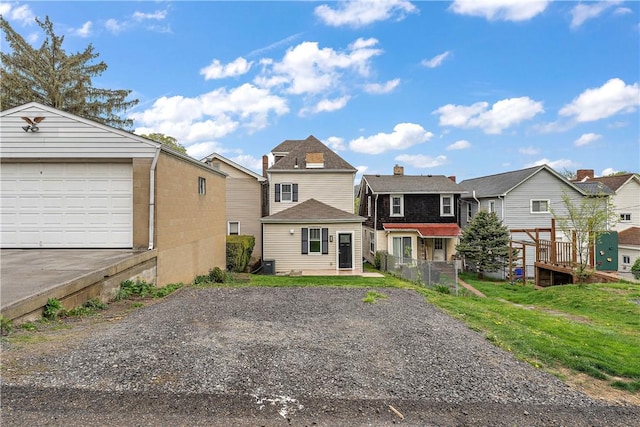 view of front of property featuring a residential view and an outdoor structure