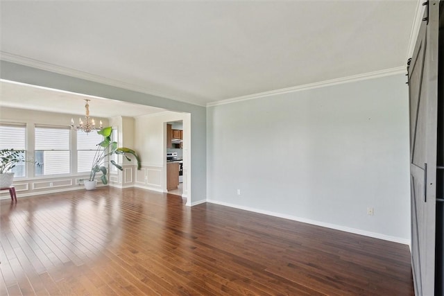 921 Bideford Dr, South Park, PA 15129 - unfurnished living room with a chandelier, dark wood finished floors, crown molding, and baseboards