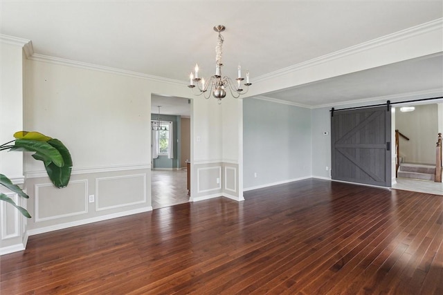 921 Bideford Dr, South Park, PA 15129 - spare room featuring a chandelier, hardwood / wood-style flooring, a barn door, crown molding, and a decorative wall