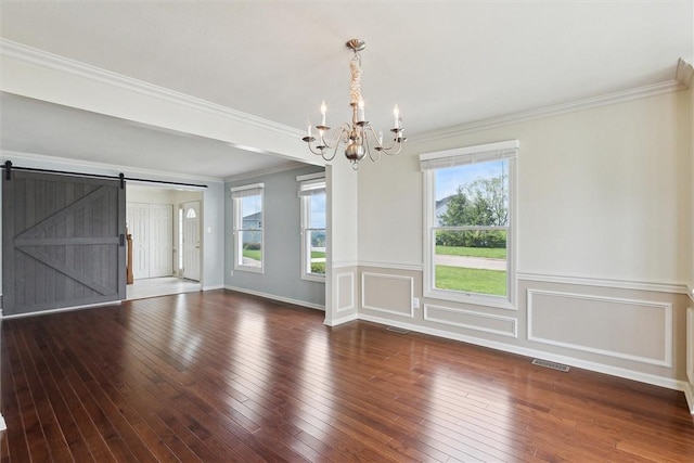 921 Bideford Dr, South Park, PA 15129 - unfurnished dining area with a chandelier, wood-type flooring, crown molding, a barn door, and wainscoting