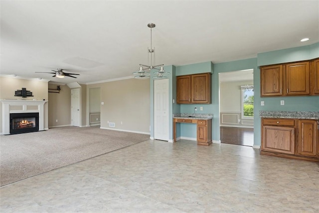 921 Bideford Dr, South Park, PA 15129 - unfurnished living room with a ceiling fan, baseboards, crown molding, a fireplace with flush hearth, and a chandelier