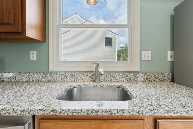 921 Bideford Dr, South Park, PA 15129 - kitchen view of a sink, light stone counters, and brown cabinets
