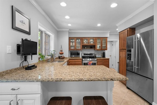 401 Parker Dr, Mt Lebanon, PA 15216 - kitchen featuring appliances with stainless steel finishes, a sink, a peninsula, brown cabinets, and ornamental molding