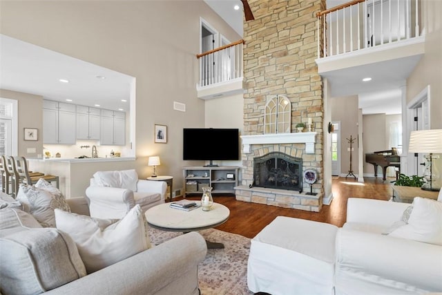 149 Walnut Ridge Dr, Chippewa Twp, PA 15010 - living room with wood finished floors, a high ceiling, baseboards, a fireplace, and recessed lighting