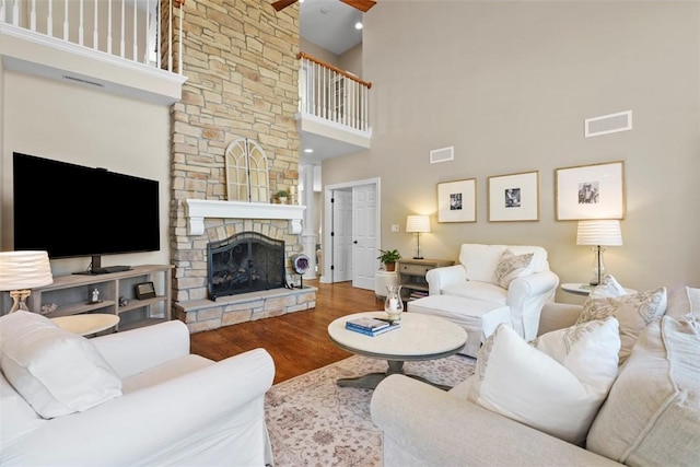 149 Walnut Ridge Dr, Chippewa Twp, PA 15010 - living area featuring a high ceiling, wood finished floors, a stone fireplace, and ceiling fan