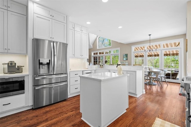 149 Walnut Ridge Dr, Chippewa Twp, PA 15010 - kitchen featuring stainless steel appliances, a peninsula, light countertops, a kitchen island, and a chandelier