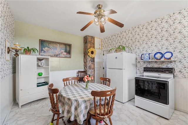 134 Modisette Ave, Donora, PA 15033 - dining room with wallpapered walls, a wainscoted wall, light marble finish floors, and ceiling fan