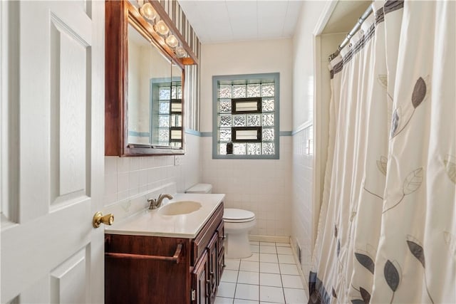 134 Modisette Ave, Donora, PA 15033 - bathroom with toilet, tile walls, tile patterned flooring, vanity, and a wainscoted wall
