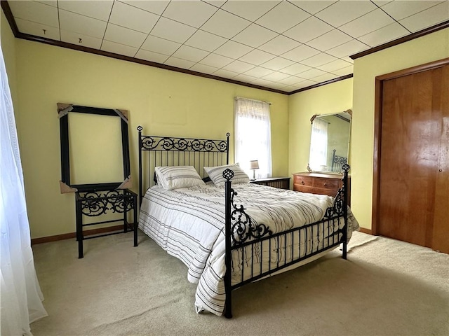 bedroom featuring ornamental molding, carpet floors, and baseboards