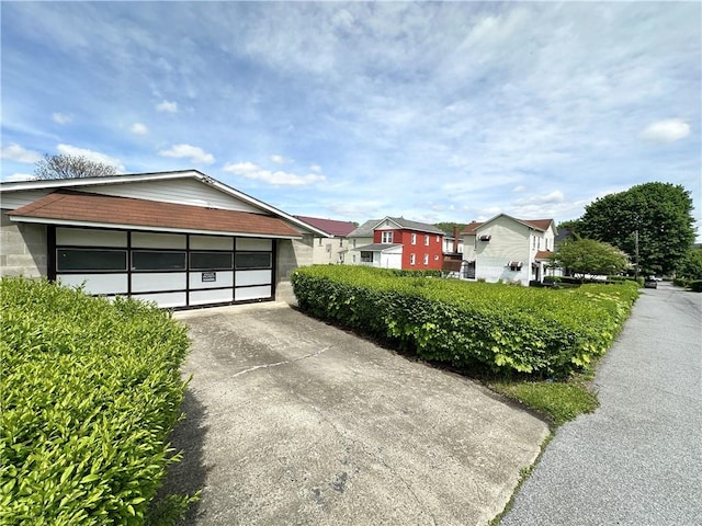 view of front of property featuring driveway and a residential view