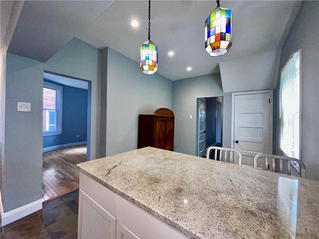 kitchen with white cabinetry, decorative light fixtures, baseboards, and recessed lighting