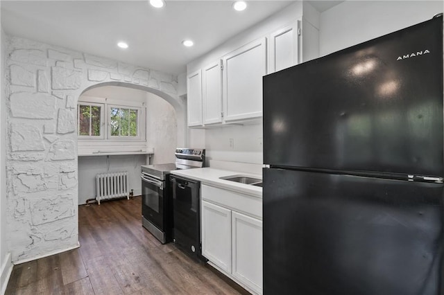 1008 Lowery St, Duquesne, PA 15110 - kitchen with black appliances, radiator, white cabinets, dark wood-style flooring, and light countertops