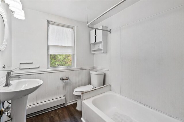 1008 Lowery St, Duquesne, PA 15110 - bathroom with baseboard heating, toilet, a wainscoted wall, wood finished floors, and shower / washtub combination