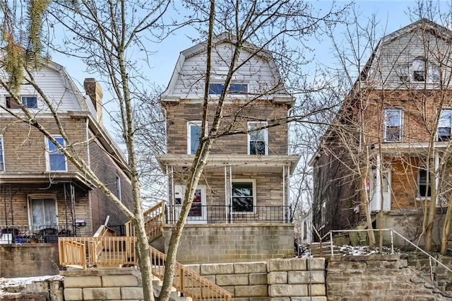 colonial inspired home featuring stairs, a gambrel roof, and a porch