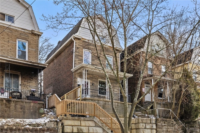 view of front facade featuring stairway and a porch