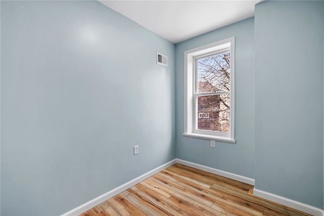 empty room featuring light wood-style flooring and baseboards