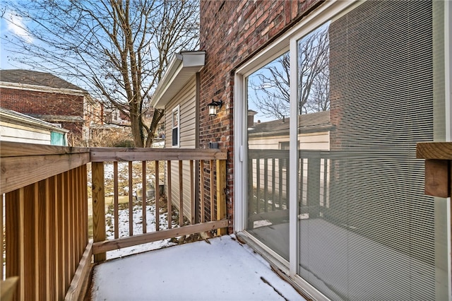 view of snow covered back of property