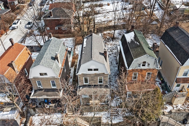 snowy aerial view with a residential view