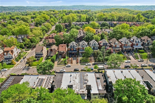 aerial view of property's location with nearby suburban area and a forest