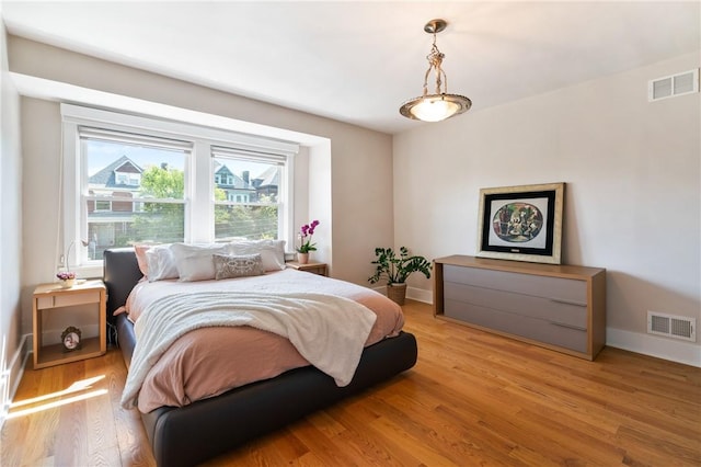 bedroom with light wood-style flooring and baseboards