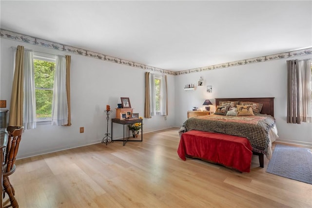 bedroom with wood finished floors and baseboards