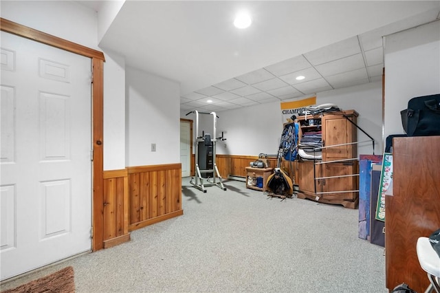 carpeted office with a wainscoted wall, a paneled ceiling, wooden walls, and recessed lighting