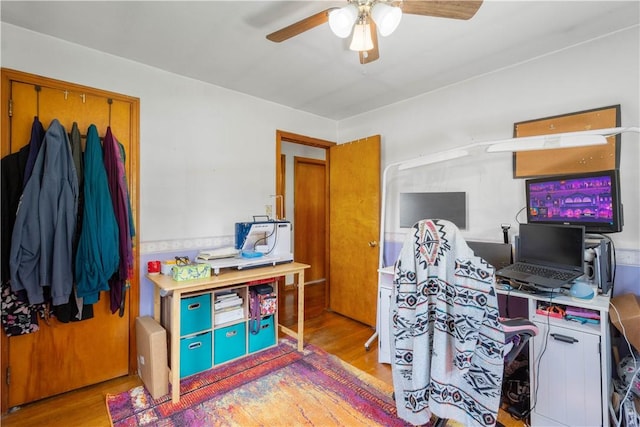 office with wood finished floors and a ceiling fan