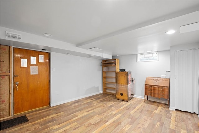 below grade area featuring wood finished floors and baseboards
