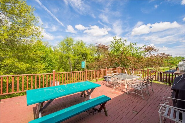 wooden terrace featuring outdoor dining space