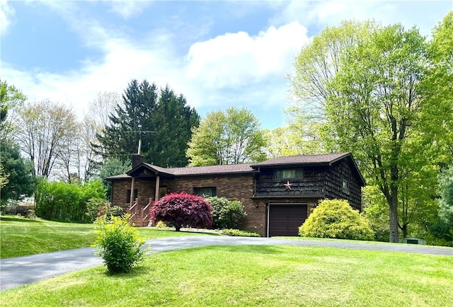 358 Crisswell Rd, Penn Twp But, PA 16002 - view of front facade with asphalt driveway, a front yard, brick siding, an attached garage, and a chimney