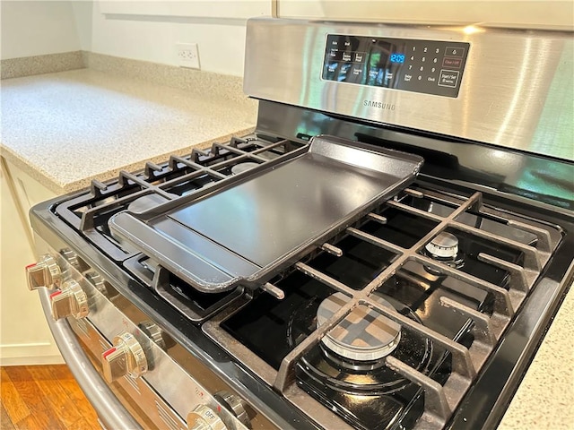 6927 Perrysville Ave, Ben Avon, PA 15202 - kitchen view of stainless steel gas range oven and wood finished floors