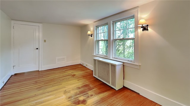 6927 Perrysville Ave, Ben Avon, PA 15202 - unfurnished room featuring radiator heating unit, light wood finished floors, and baseboards