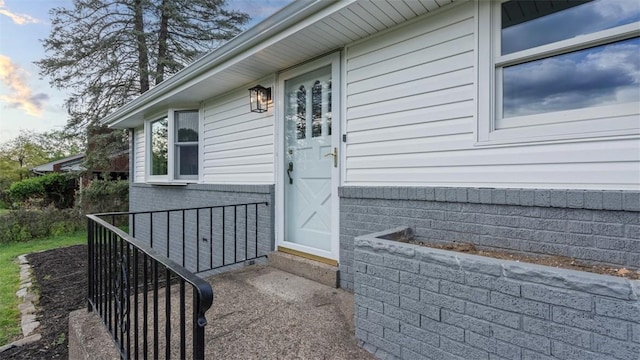 entrance to property with brick siding