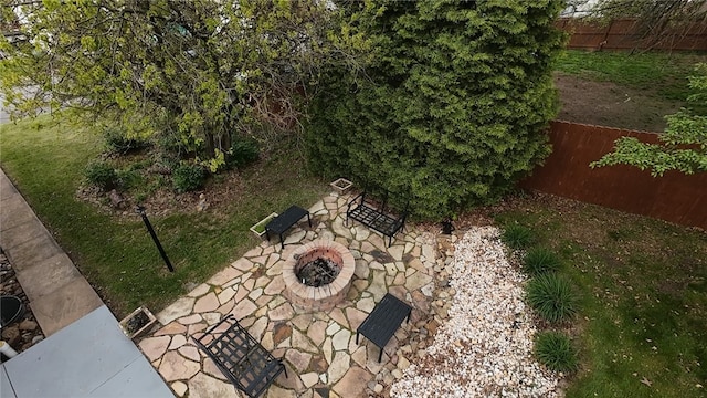 exterior view of fence and an outdoor fire pit