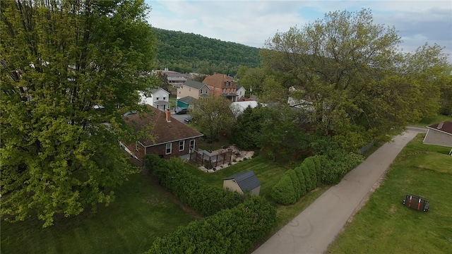 aerial view of property's location with a heavily wooded area
