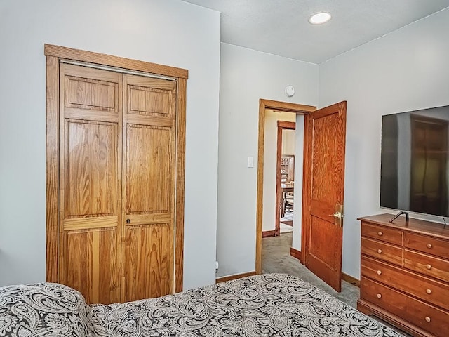 carpeted bedroom with baseboards, a closet, and recessed lighting