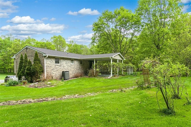 back of house featuring a yard and central air condition unit