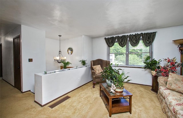 living area with light colored carpet, a chandelier, and baseboards