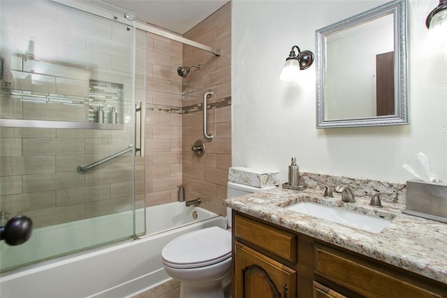 bathroom with toilet, shower / bath combination with glass door, and vanity