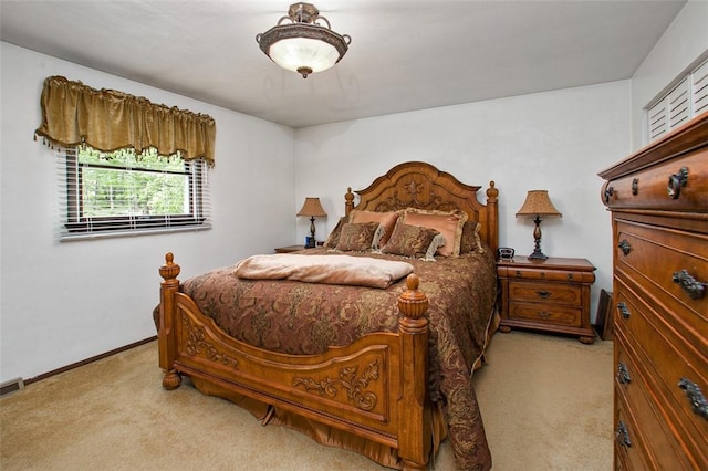 bedroom featuring light colored carpet and baseboards