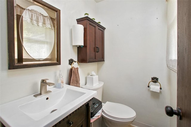 half bathroom with toilet and vanity