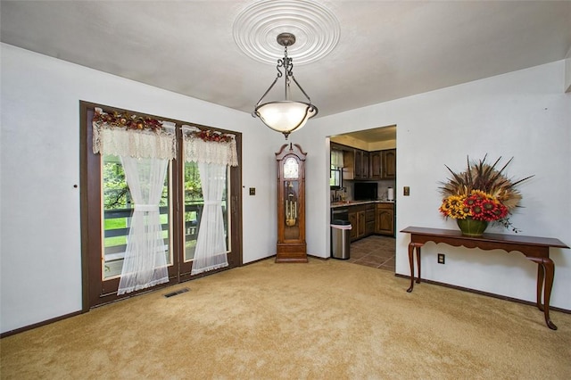 dining room with light carpet and baseboards