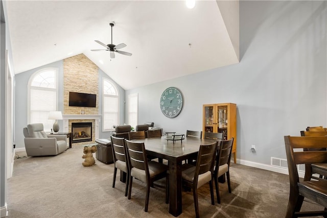 112 Shelton Place Dr, Connoquenessing Boro, PA 16033 - dining room featuring high vaulted ceiling, ceiling fan, carpet, a stone fireplace, and baseboards