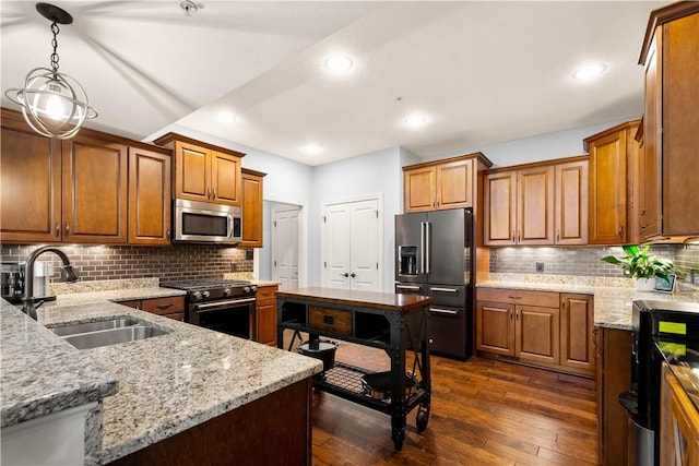 112 Shelton Place Dr, Connoquenessing Boro, PA 16033 - kitchen featuring appliances with stainless steel finishes, a sink, dark wood-style floors, tasteful backsplash, and light stone countertops