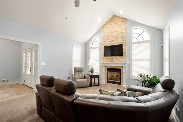 112 Shelton Place Dr, Connoquenessing Boro, PA 16033 - living area featuring light carpet, a stone fireplace, a ceiling fan, baseboards, and high vaulted ceiling