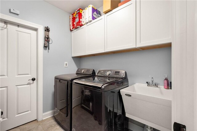 112 Shelton Place Dr, Connoquenessing Boro, PA 16033 - laundry room with washing machine and dryer, cabinet space, baseboards, and light tile patterned floors