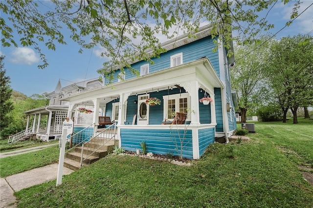 154 E Kittanning St, W/N Mahoning Twps, PA 16256 - view of front of property with a porch, a front yard, and central AC unit